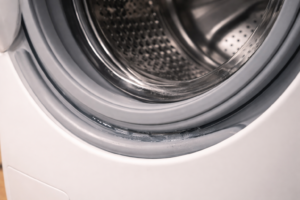 Washing machine door seal with light water residue along lower edge