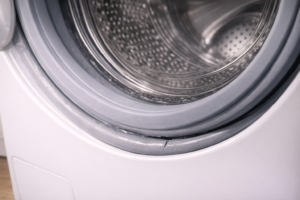 Cracked rubber washing machine door seal showing visible damage along inner edge